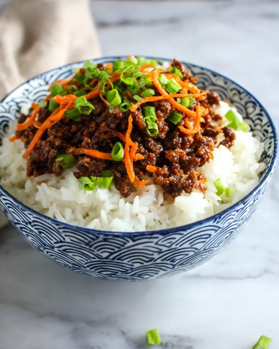A white bowl with blue wave patterns is filled with two main layers: the bottom layer is plain white rice with a soft, fluffy texture, and the top layer is dark brown cooked meat mixed with thin, curly orange carrot strips, garnished with small pieces of bright green chopped spring onions scattered on top. The bowl sits on a white marbled surface with a soft, blurred background. photo taken with an iphone --ar 4:5 --v 7