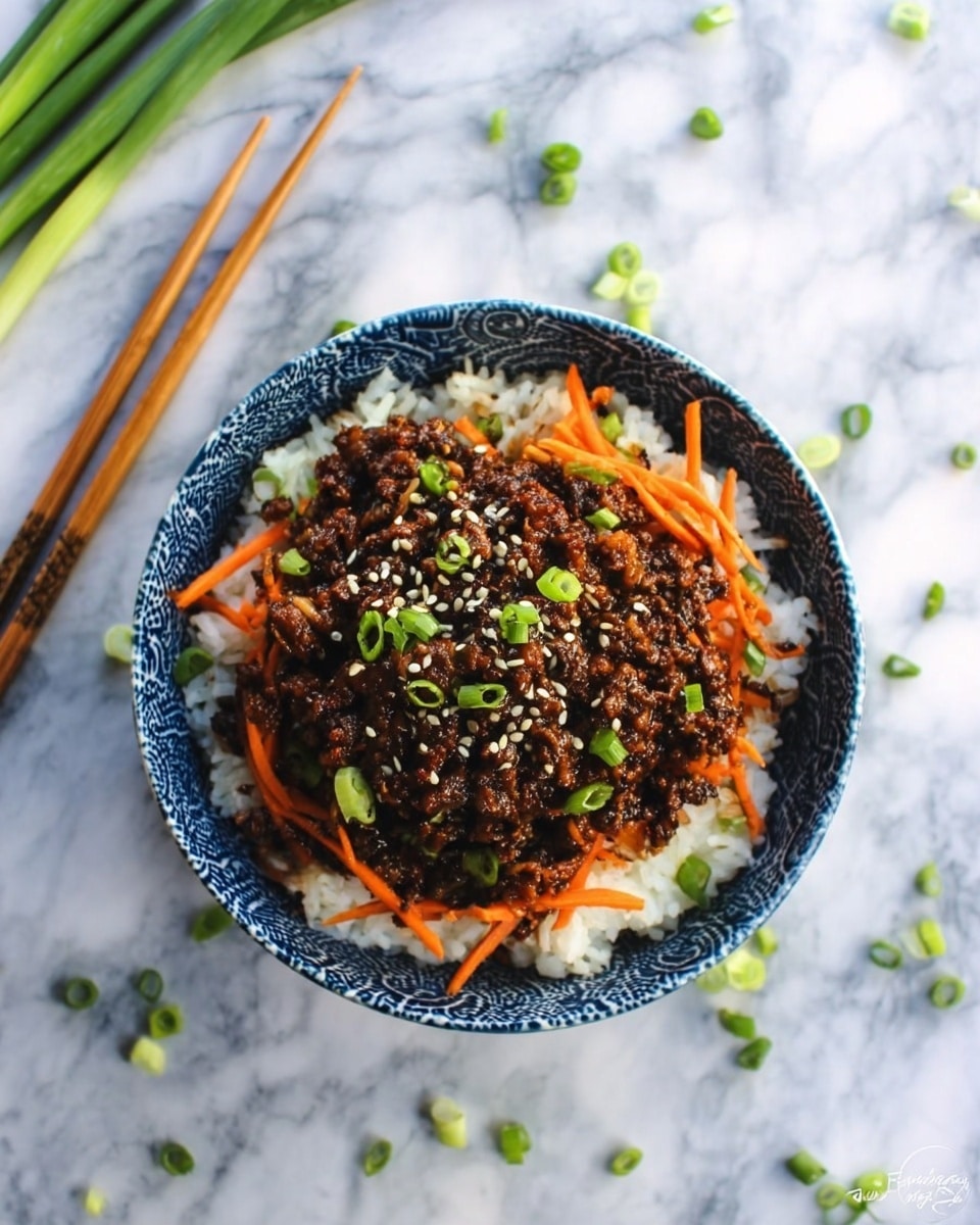 A blue and white patterned bowl holds a dish with a base layer of white rice, topped with a dark brown minced meat mixture mixed with thin orange carrot strips. The meat layer is garnished with small green onion pieces and white sesame seeds scattered on top. The bowl sits on a white marbled texture background with a pair of wooden chopsticks resting nearby. Some green onion pieces are scattered around on the surface. Photo taken with an iphone --ar 4:5 --v 7