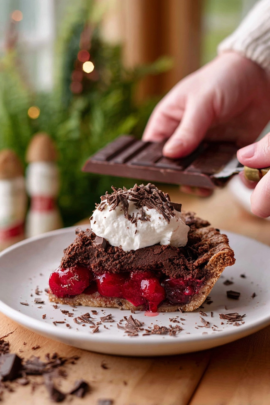 Chocolate Cherry Black Forest Pie, Black Forest Pie with Cherries, Chocolate Cherry Dessert, Cherry Pie with Mascarpone, Easy Black Forest Pie - A slice of dark brown chocolate pie with a rough textured top layer sits on a white plate, revealing a thick, bright red cherry filling in the middle layer. On top of the pie slice, there is a dollop of white cream with small dark chocolate shavings scattered over it and around the plate. In the background, a woman’s hand is holding a dark chocolate bar and scraping chocolate shavings. The scene is set on a wooden surface with a soft focus of green plants and warm-toned decor in the background, all on a white marbled texture. photo taken with an iphone --ar 2:3 --v 7