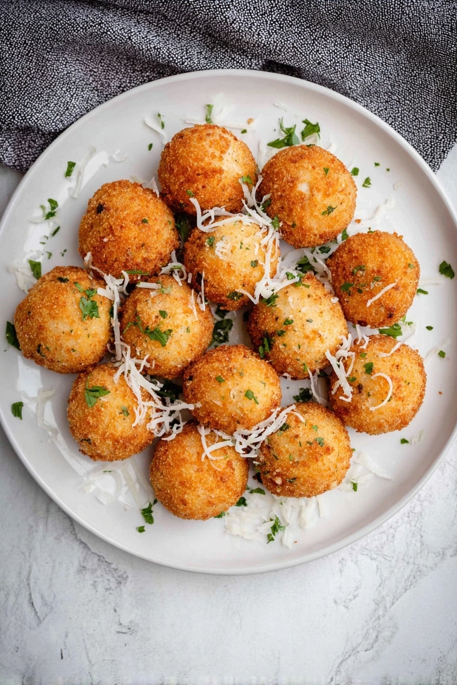 Crispy Mashed Potato Balls with Cheddar and Green Onions, mashed potato balls, cheesy potato appetizers, crispy potato bites, savory snack ideas - A close view of one bright golden brown fried ball being pulled apart by two woman's hands, revealing a soft, cheesy white inside with bits of green herbs mixed in, and a slight stringy cheese pull between the two halves. In the background, many more similar golden brown fried balls with small green herb pieces are scattered on a white plate, all set on a white marbled surface. photo taken with an iphone --ar 2:3 --v 7