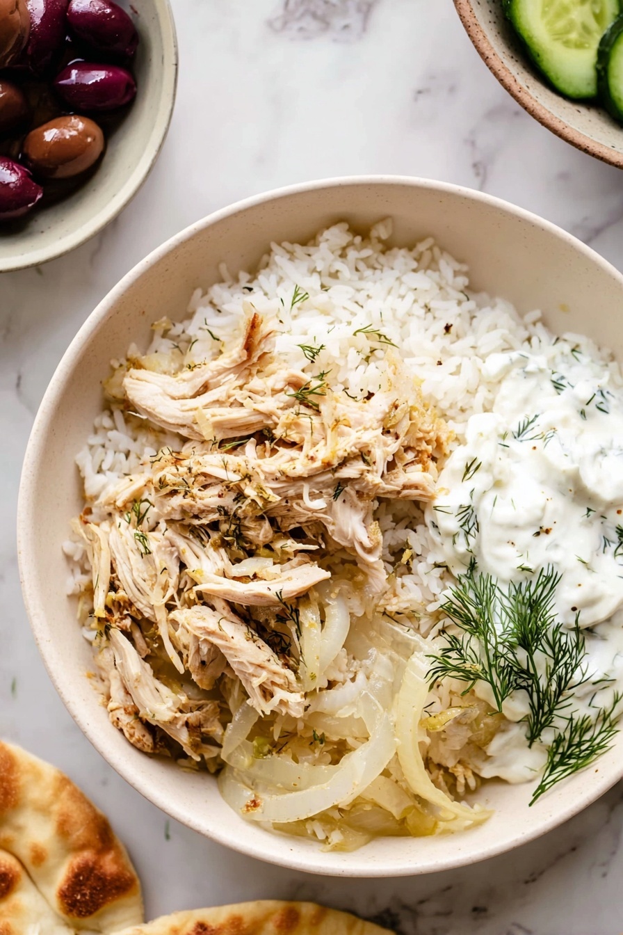 Slow Cooker Greek Chicken, Greek Chicken recipe, Mediterranean chicken, easy slow cooker dinners, lemon garlic chicken - A white bowl on a white marbled surface filled with three main layers: the bottom layer is white rice with a fluffy texture, the middle layer consists of cooked translucent onion slices with light browning, and on top are shredded light beige chicken pieces seasoned with herbs. On one side of the bowl, a dollop of white creamy sauce with green dill leaves is placed. Around the bowl, on the white marbled surface, there is a partial view of a white bowl holding dark purple olives and green cucumber slices, and a woman's hand is holding a piece of light golden flatbread. photo taken with an iphone --ar 2:3 --v 7