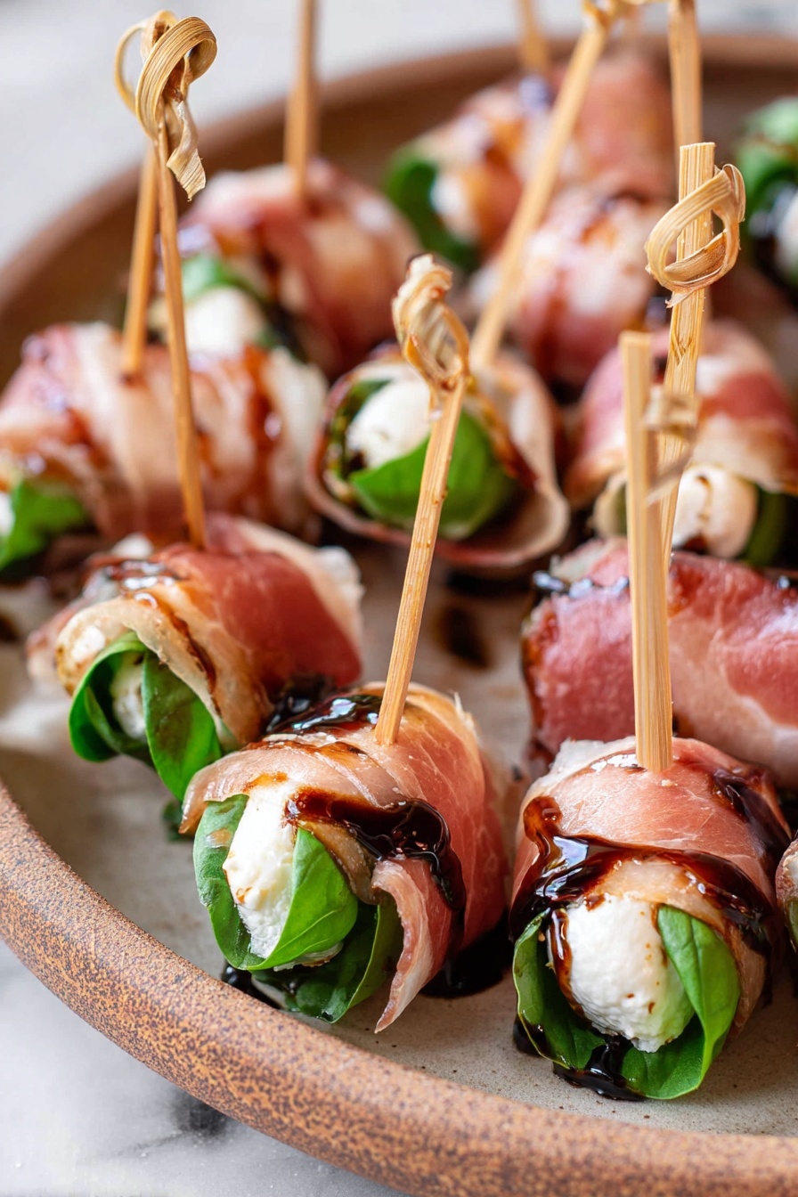 Prosciutto Mozzarella Bites with Basil, prosciutto appetizer, mozzarella appetizer, basil appetizer, easy prosciutto bites - The image shows many small rolls arranged closely on a beige plate with a rustic look, all placed on a white marbled surface. Each roll has three visible layers: a dark green fresh basil leaf inside, a white creamy cheese layer wrapped around the leaf, and a thin, translucent pink cured meat layer folded around the outside. Each roll is pierced with a light brown wooden skewer with a small knot at the top, and a glossy dark brown balsamic glaze is lightly drizzled on top, adding a shiny, sticky texture. Photo taken with an iphone --ar 2:3 --v 7