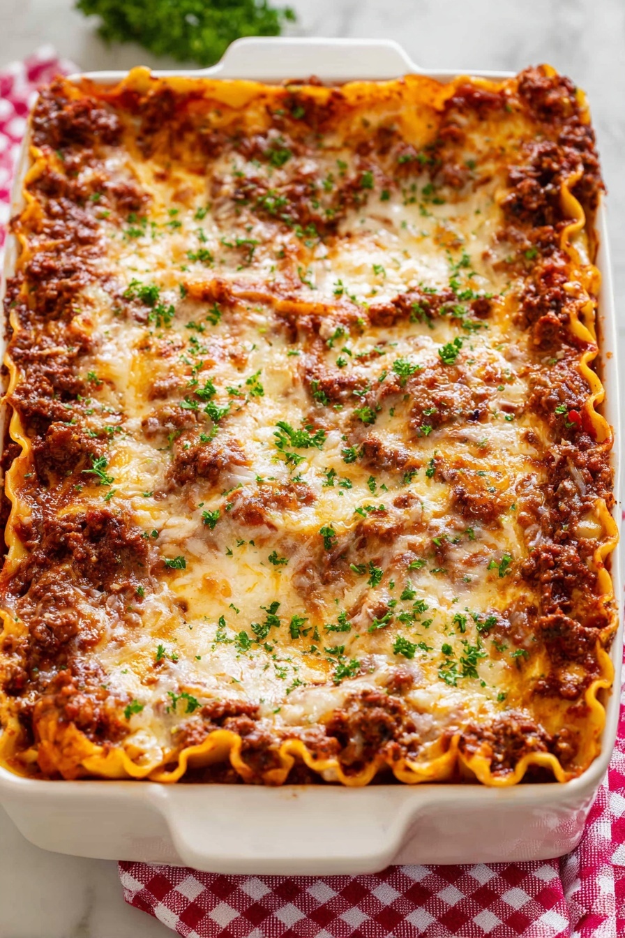 Best Ever Classic Meat Lasagna, homemade meat lasagna, cheesy meat lasagna, hearty lasagna recipe, family favorite lasagna - A white rectangular baking dish holds a thick lasagna with about five layers visible; the bottom layer is flat orange pasta sheets, followed by a rich dark brown meat sauce, then another layer of pasta, meat sauce, and a top layer covered in melted golden cheese with brown spots. Small bits of fresh green parsley are sprinkled evenly on top, adding a fresh touch. The dish sits on a red and white checkered cloth over a white marbled surface. photo taken with an iphone --ar 2:3 --v 7