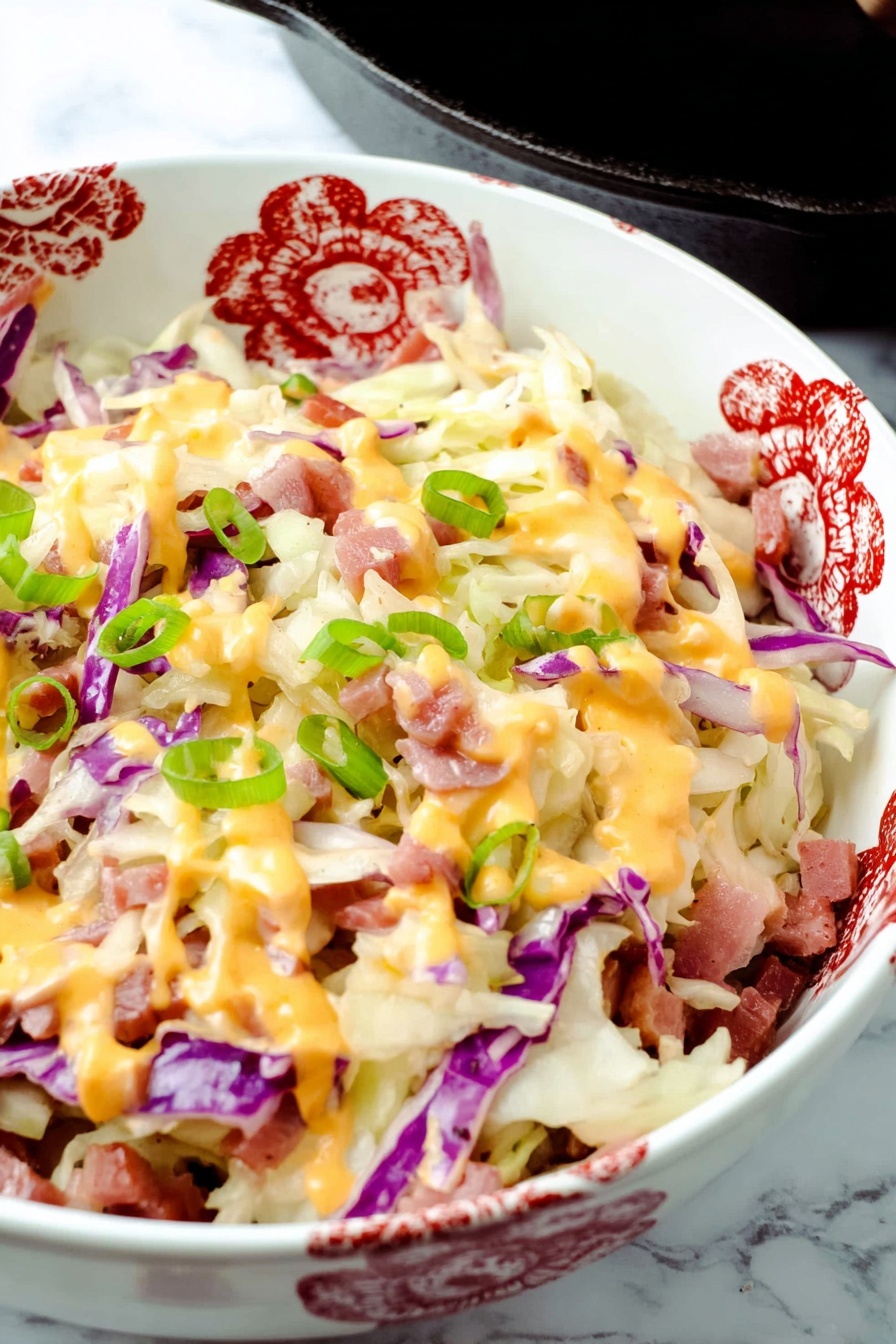 Keto Reuben Bowl with Corned Beef, low-carb Reuben bowl, keto sandwich alternative, easy keto meal, healthy Reuben-inspired dish - The dish is shown in a black cast iron skillet filled with layers of shredded white and purple cabbage, small pieces of thinly sliced reddish meat, melted creamy white and orange cheeses drizzled on top, and sprinkled with bright green chopped onions. The cabbage forms the base with soft, thin textures, scattered evenly across the skillet. The meat pieces are scattered between the cabbage layers, adding a touch of reddish brown color. The cheese layers blend smoothly over the top with thick drips of orange sauce and melted white cheese covering the surface. Bright green onion pieces are spread on top in small round slices for a fresh look. The skillet sits on a white marbled surface with a white cloth visible in the background. photo taken with an iphone --ar 2:3 --v 7