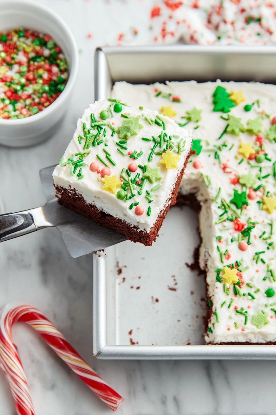 Festive Red Velvet Christmas Dessert, holiday dessert, Christmas cake, red velvet holiday treat, festive layered dessert - A square piece of cake with two layers is lifted by a spatula above a white marbled surface. The cake’s bottom layer is chocolate brown, and the top is a thick white frosting spread evenly. The frosting is decorated with various colorful sprinkles, including green thin rods, small round pearls in pastel colors, yellow star shapes, and green Christmas tree shapes with red round sprinkles. The cake is in a silver baking pan with one piece missing from it. Nearby, there is a white bowl filled with green, red, and white holiday sprinkles. Two candy canes lie on the white marbled surface below the pan. Photo taken with an iphone --ar 2:3 --v 7