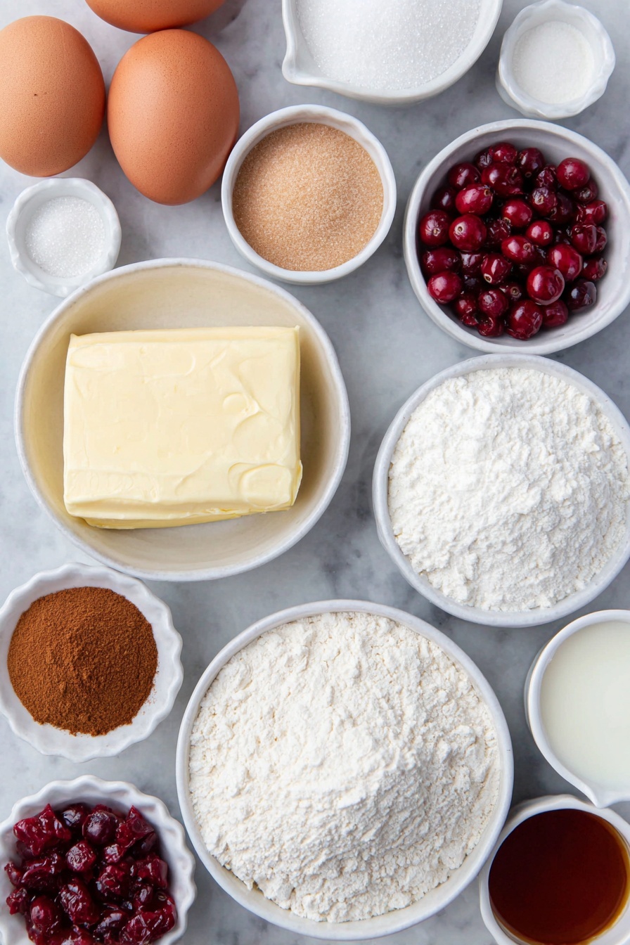 Cranberry Crumble Bars with Shortbread, cranberry bars, shortbread dessert recipes, seasonal cranberry bars, easy holiday fruit bars - Flat lay of fresh unsalted butter in a small white ceramic bowl, two brown eggs with clean shells, a small white bowl filled with granulated sugar, a small white bowl of light brown packed sugar, a small white bowl of sifted powdered sugar, a small white bowl of all-purpose flour, a small white bowl of baking powder, a small white bowl of ground cinnamon, a small white bowl of kosher salt, a small white bowl of cornstarch, a handful of fresh bright red cranberries, a few strands of orange zest next to a small white bowl of fresh orange juice, a small white bowl of vanilla extract, and a small white bowl of whole milk, all evenly spaced and arranged symmetrically on a clean white marble surface, soft natural light, photo taken with an iPhone, professional food photography style, fresh ingredients, white ceramic bowls, no bottles, no duplicates, no utensils, no packaging --ar 2:3 --v 7 --p m7354615311229779997