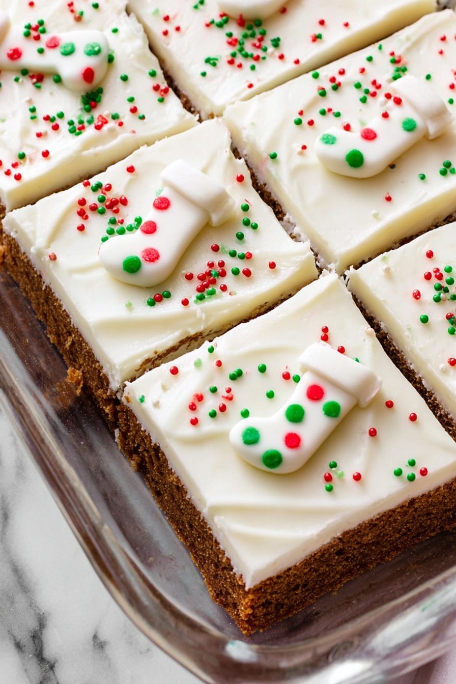 Spiced Gingerbread Cookie Bars, gingerbread bar recipe, holiday cookie bars, soft chewy gingerbread, festive dessert bars - The image shows a baking dish filled with a dessert cut into six square pieces. Each piece has two visible layers: a thick brown crumbly base and a thick smooth white frosting layer on top. The frosting is neatly spread with soft swirls and is decorated with small red, green, and white round sprinkles scattered evenly. Each piece also has a small white candy shaped like a Christmas stocking, decorated with red and green dots. The dish is placed on a white marbled surface. photo taken with an iphone --ar 2:3 --v 7