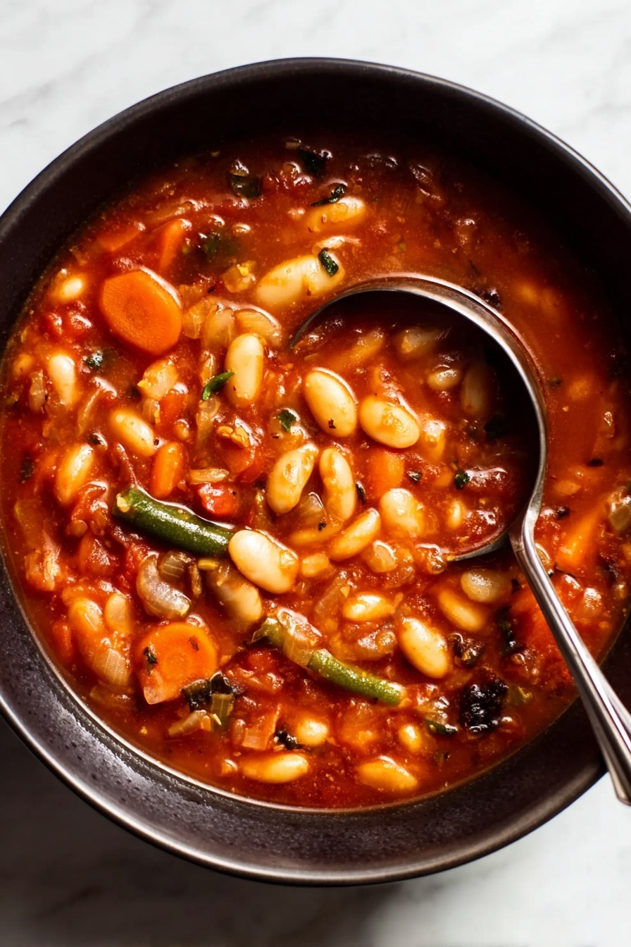 Easy Vegetable Minestrone Soup, vegetable minestrone soup, hearty vegetable soup, healthy minestrone recipe, quick vegetable soup - A close-up view of a dark bowl filled with a thick soup that has many white beans, slices of orange carrots, and small pieces of green beans mixed in a rich, reddish-brown broth. The soup looks chunky with visible bits of vegetables and herbs throughout, giving it a hearty and comforting appearance. A shiny silver ladle with a long handle rests inside the bowl, partially submerged in the soup, with the handle leaning on the edge of the bowl. The bowl sits on a white marbled surface. Photo taken with an iphone --ar 2:3 --v 7