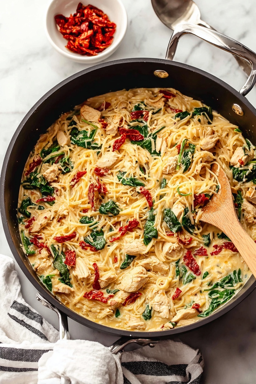 Tuscan Chicken with Spaghetti Squash, healthy Tuscan chicken dinner, easy low-carb chicken recipe, flavorful spaghetti squash recipes, quick Tuscan chicken dish - A large black pan filled with a creamy pasta dish that has three main layers: the creamy sauce with melted cheese forms the base, mixed through with tender pieces of seasoned light brown chicken, bright green spinach leaves, and small chunks of red sun-dried tomatoes scattered evenly throughout. A light wooden spoon is stirring the mixture from the right side of the pan. Near the pan, on a white marbled surface, sits a small white bowl filled with more red sun-dried tomatoes and a silver spoon nearby. A white cloth with black stripes is placed casually under the pan handle. Photo taken with an iphone --ar 2:3 --v 7