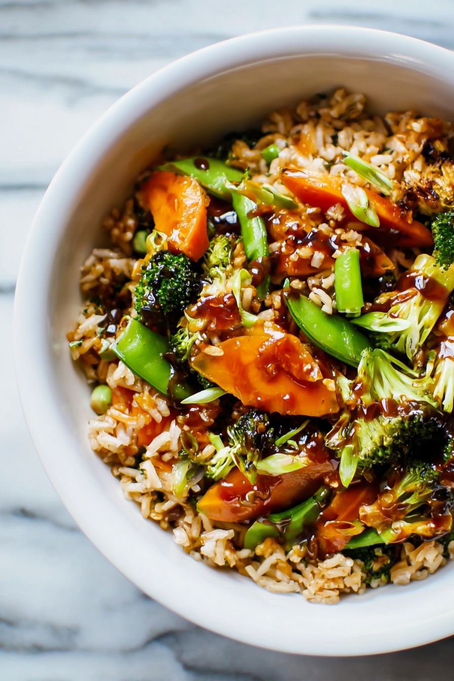 Teriyaki Chicken Casserole, Easy teriyaki chicken bake, one-pan chicken casserole, Japanese-inspired chicken dish, savory baked chicken recipe - The image shows a white bowl filled with a colorful stir-fry dish on a white marbled surface. The dish has three main layers: at the bottom, there is a layer of cooked rice with a light brown color and fluffy texture. The middle layer contains a mix of bright orange baby carrots, green snap peas, and small broccoli florets, giving the dish a fresh and vibrant look. The top layer is a light drizzle of dark brown sauce covering parts of the rice and vegetables, adding a shiny finish. The overall look is warm and inviting, with a mix of soft and crisp textures visible. Photo taken with an iphone --ar 2:3 --v 7