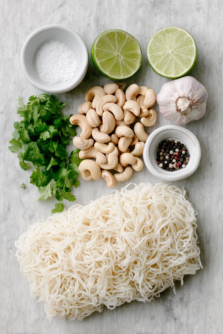 Vegan Cilantro Lime Noodles, vegan noodle recipes, cilantro lime pasta, easy vegan dinner ideas, quick healthy vegan meals - Flat lay of raw cashews in a small pile, a small handful of bright green cilantro sprigs, two whole uncracked garlic cloves, a whole fresh lime with one half cut to show the juicy interior and scattered lime zest, a small white ceramic bowl filled with clear water, a small white ceramic bowl containing coarse salt, a small white ceramic bowl with cracked black peppercorns, and a neat bundle of tofu shirataki spaghetti shaped noodles, all arranged in perfect symmetry on a clean white marble surface, soft natural light, photo taken with an iPhone, professional food photography style, fresh ingredients, white ceramic bowls, no bottles, no duplicates, no utensils, no packaging --ar 2:3 --v 7 --p m7354615311229779997