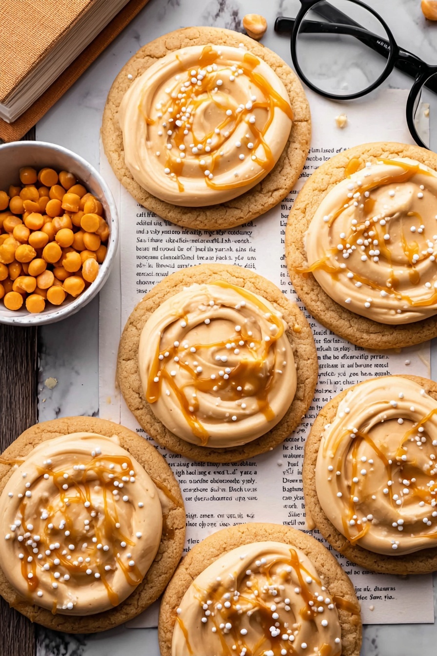 Harry Potter Butterbeer Cookies, magical butterbeer treats, wizarding cookie recipe, butterscotch cookies, Harry Potter themed desserts - The image shows six soft round cookies laid out on a white marbled surface covered by some text pages. Each cookie has two layers: a light tan cookie base and a thick swirl of creamy beige frosting on top. The frosting is further decorated with an uneven drizzle of shiny caramel sauce in a golden amber color. Small white and yellow round sprinkles are scattered over the caramel on each cookie. A small white bowl filled with orange caramel chips is placed near the cookies, with a pair of black-framed reading glasses resting on the text pages next to the bowl. photo taken with an iphone --ar 2:3 --v 7